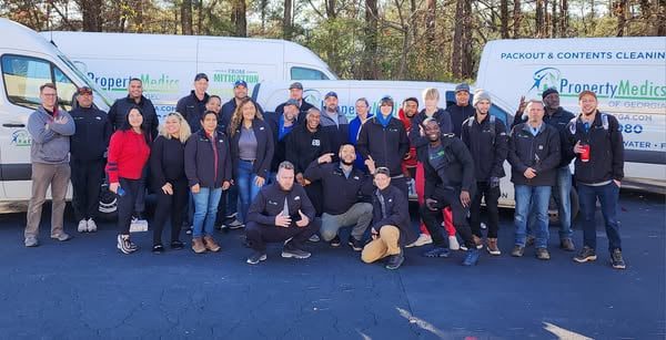 Property Medics of Georgia team members standing in front of their service vans