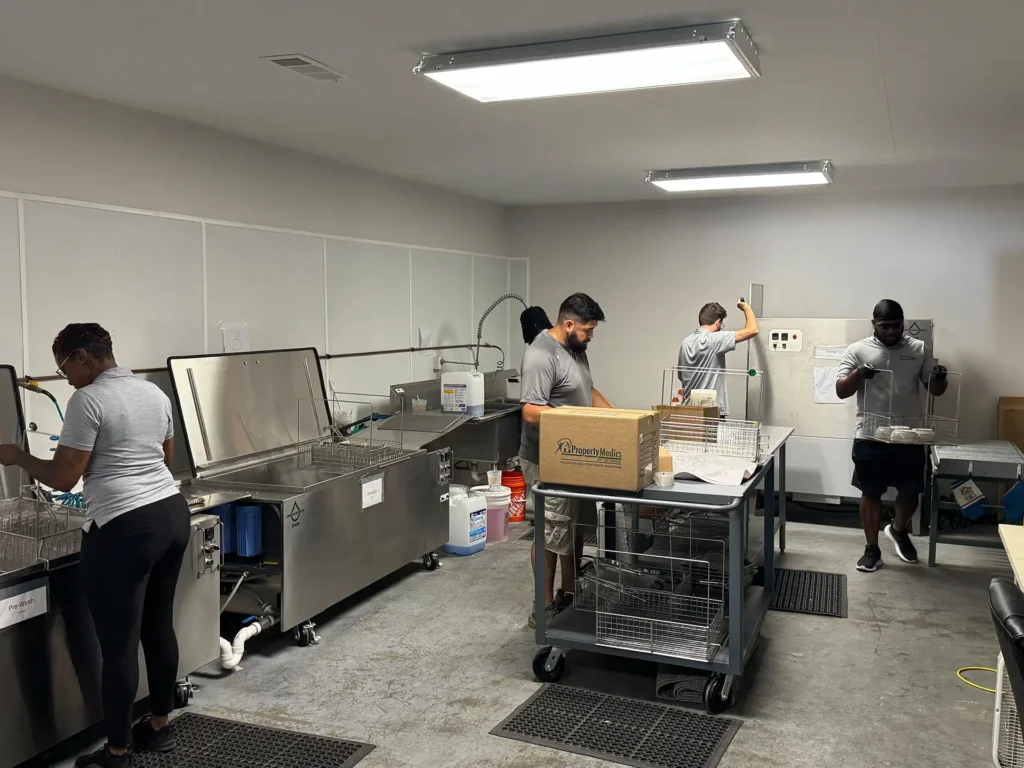 Workers cleaning the contents of household items that were effected by a flood