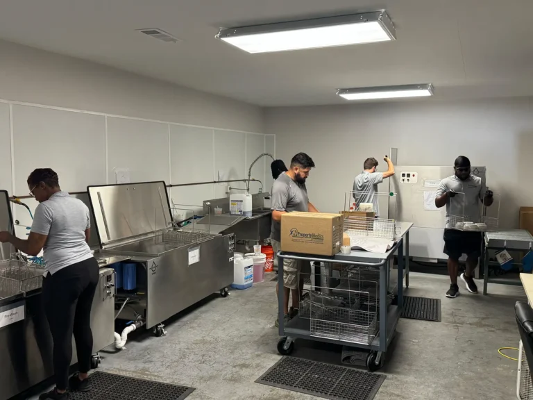 Workers cleaning the contents of household items that were effected by a flood