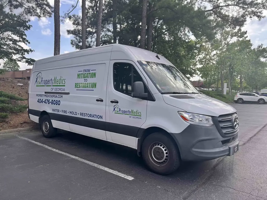 A white van with the Property Medics of Georgia logo