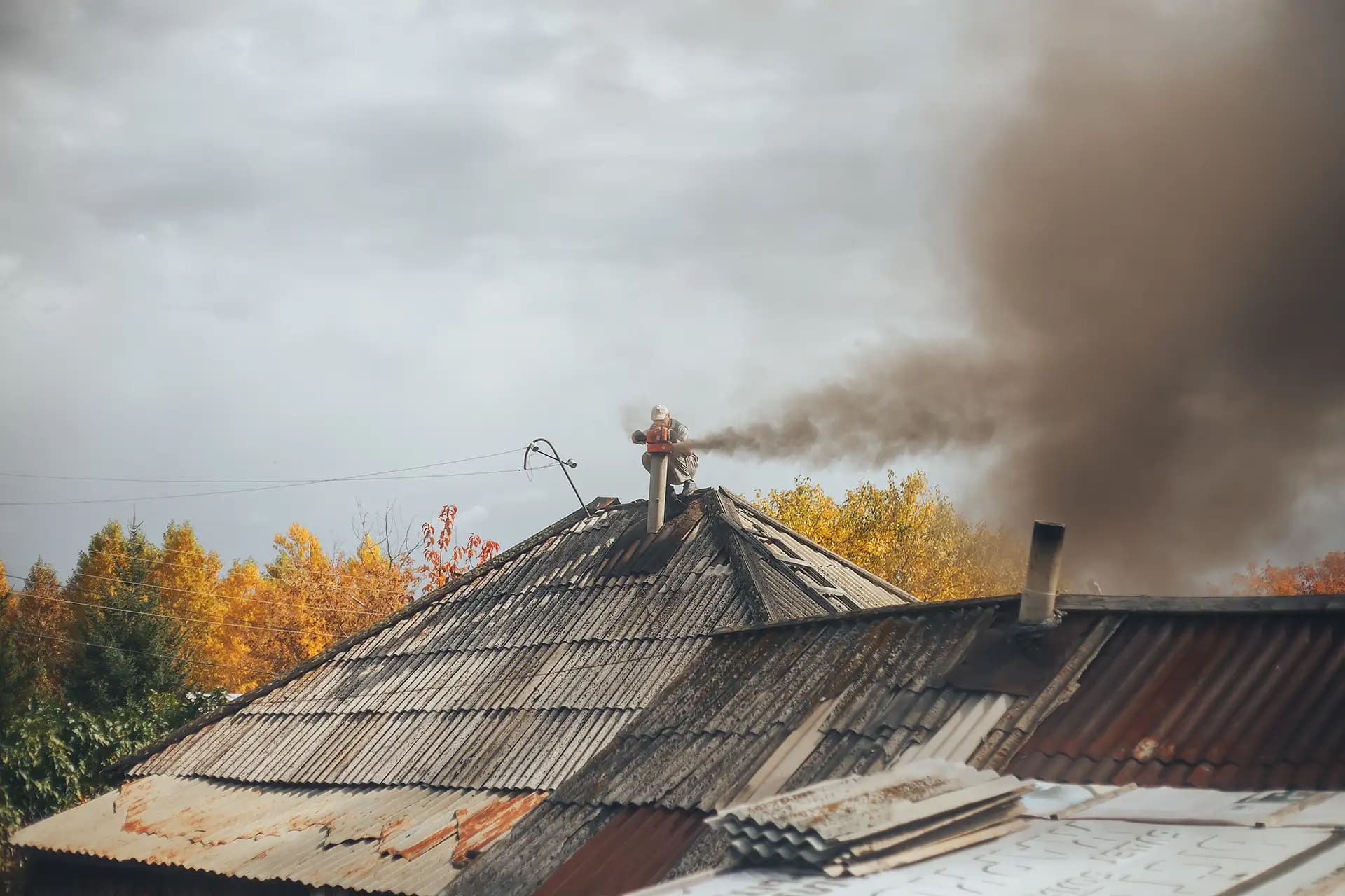 A roof with smoke from fire