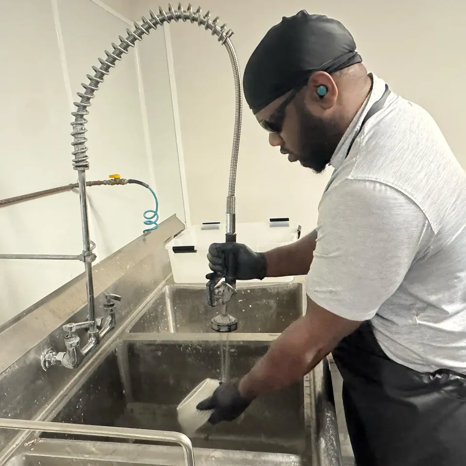 A worker cleaning dishes
