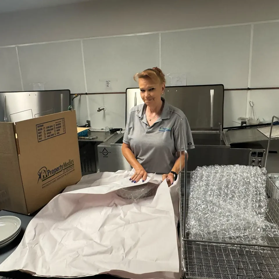 A worker cleaning and packaging contents