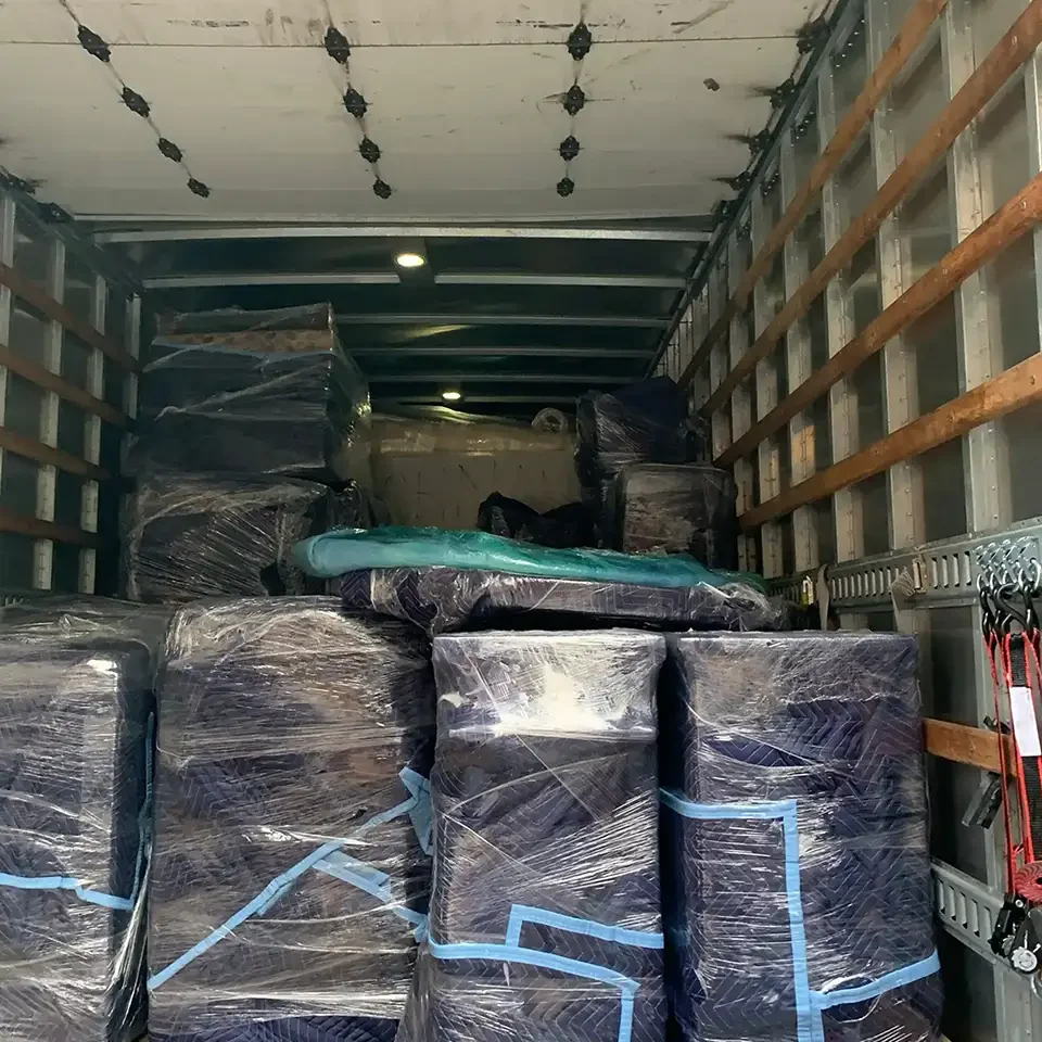 Contents wrapped in plastic in the back of a truck