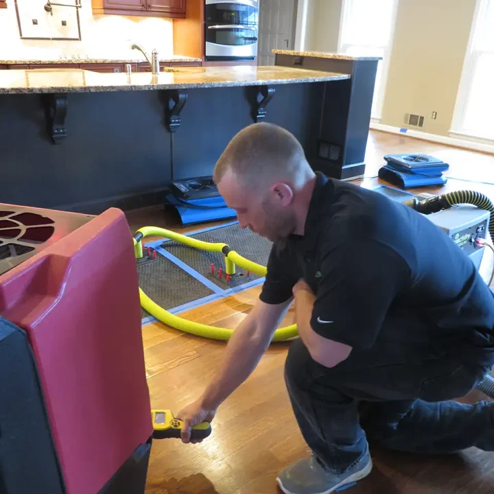 a man with water mitigation equipment